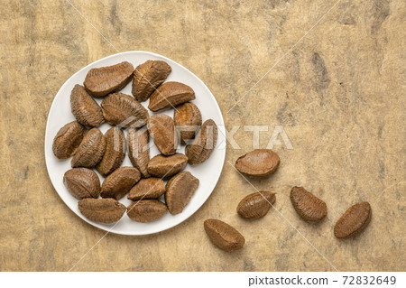 Brazilian nuts on a white plate 72832649
