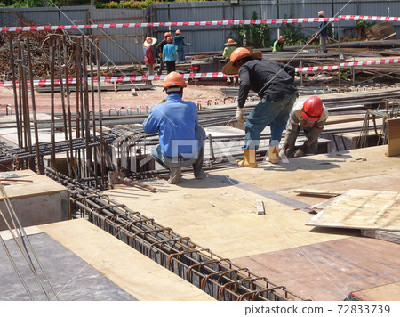 KUALA LUMPUR, MALAYSIA -JULY 16, 2017: Carpenters fabricate timber and plywood formwork at the construction site. Timber formwork as a mold to the reinforced concrete structure. KUALA LUMPUR, MALAYSIA -JULY 16, 2017: Carpenters fabricate timber and plywood formwork at the construction site. Timber formwork as a mold to the reinforced concrete structure. 72833739