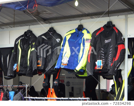 KUALA LUMPUR, MALAYSIA -SEPTEMBER 09, 2017: Motorcycle riding jackets hanging for sale.  Special safety feature for motorcycle rider was added to this jacket design.  72834298