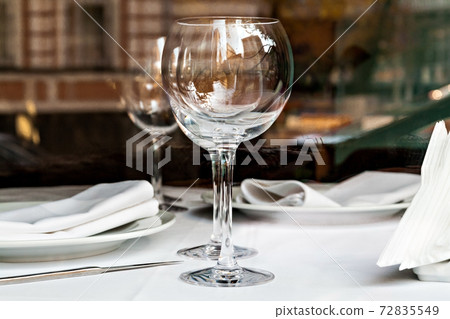 reflected in the empty glasses in a restaurant close up reflected in the empty glasses in a restaurant close up 72835549