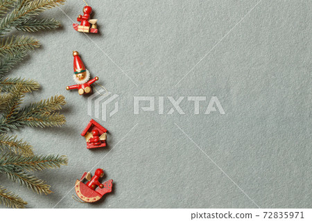 Vintage wooden toys for the Christmas tree on a gray background and fir branches. The layout of the space Vintage wooden toys for the Christmas tree on a gray background and fir branches. The layout of the space 72835971