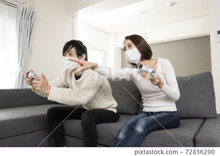 Couples enjoying the latest video games in masks / Couples enjoying games with lovers / Couples crazy about game consoles 72836200