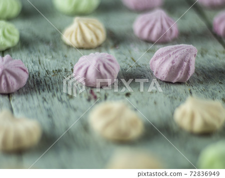 Meringue cakes on wooden background 72836949