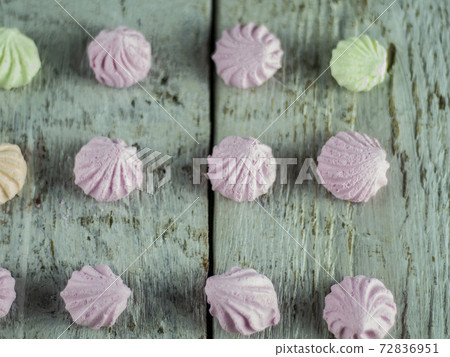 Meringue cakes on wooden background Meringue cakes on wooden background 72836951