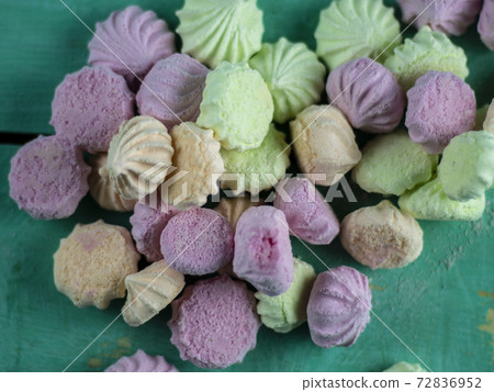 Meringue cakes on wooden background Meringue cakes on wooden background 72836952