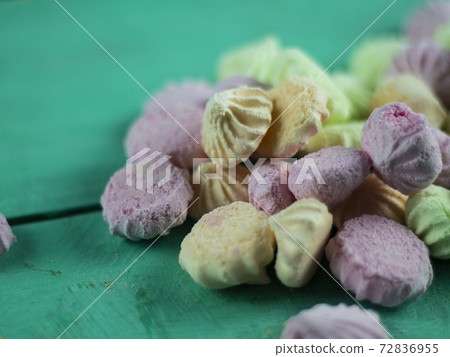 Meringue cakes on wooden background 72836955