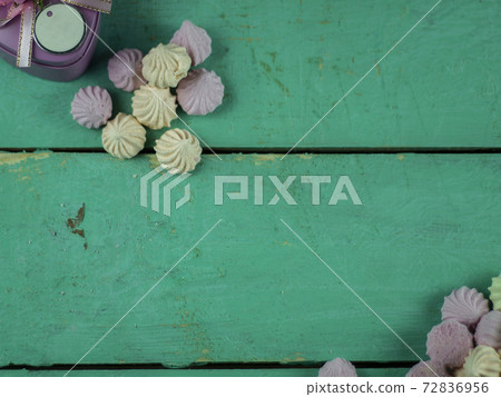 Meringue cakes on wooden background 72836956