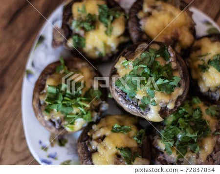 Stuffed mushrooms on a rough wooden surface 72837034