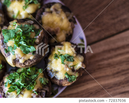 Stuffed mushrooms on a rough wooden surface Stuffed mushrooms on a rough wooden surface 72837036