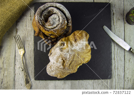 sweet buns on a rough wooden background 72837122