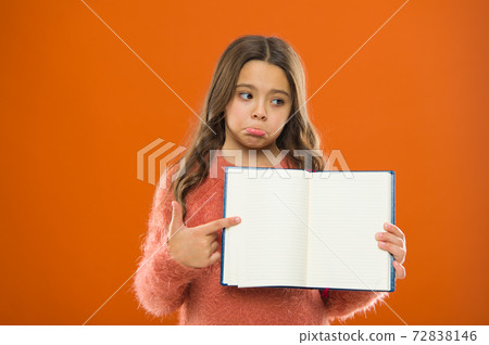 Sad news. Girl hold book orange background. Child show Sad news. Girl hold book orange background. Child show 72838146