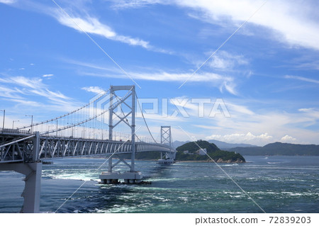 A huge suspension bridge towering against the blue sky (Onaruto Bridge, from Minamiawaji City, Hyogo Prefecture to Tokushima) 72839203