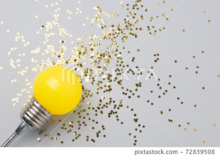 One yellow decorative lamp on a gray background. One yellow decorative lamp on a gray background. 72839508