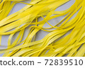 Abstract gray background with bright yellow wavy paper stripes. 72839510