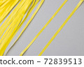 Abstract gray background with bright yellow wavy paper stripes. 72839513