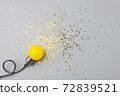 One yellow decorative lamp on a gray background. 72839521