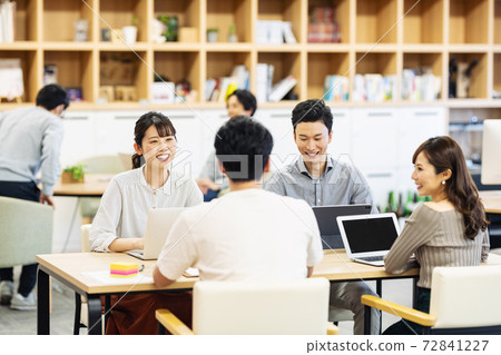 Young staff of a venture company having a meeting Young staff of a venture company having a meeting 72841227