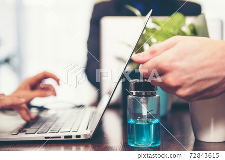 select focus. Close up of business man cleaning hands with sanitizer for protection virus select focus. Close up of business man cleaning hands with sanitizer for protection virus 72843615