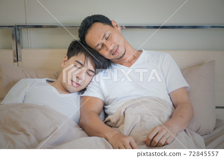 Asian Gay couples lying on the bed at home. Asian Gay couples lying on the bed at home. 72845557