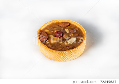 Shortcrust pastry tart with nuts and caramel on a light background. Home delivery. Festive concept. Quarantine. Shortcrust pastry tart with nuts and caramel on a light background. Home delivery. Festive concept. Quarantine. 72845681
