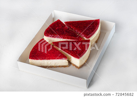 Cheesecake on a light background. Top with raspberry jelly. Home delivery. Festive concept. Quarantine. Cheesecake on a light background. Top with raspberry jelly. Home delivery. Festive concept. Quarantine. 72845682