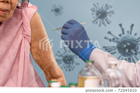 Doctor doing vaccine injection to senior woman. Doctor doing vaccine injection to senior woman. 72845810