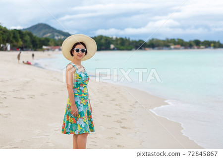 Asian middle aged woman relaxing at chaweng beach in koh samui ,Thailand. 72845867
