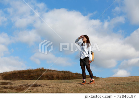 outdoor girl walk on the peak, have a good view on the top mountain range, to look far into the distance in good weather in Nara, Japan. clouds background 72846197