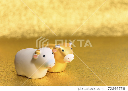 A greeting card with a cute golden and white cow figure on a silver paper background to celebrate the year of the ox. A greeting card with a cute golden and white cow figure on a silver paper background to celebrate the year of the ox. 72846756