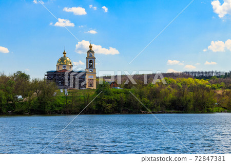 View of the beautiful lake and old orthodox church on a shore View of the beautiful lake and old orthodox church on a shore 72847381