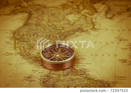 Compass on a vintage world map. Retro style 72847420