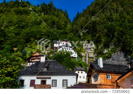 Spectacular Buildings Beneath Waterfall In The Lakeside Town Hallstatt in Austria 72850002