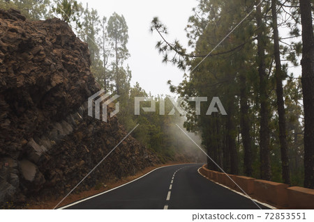 mountain road with dense mist clouds 72853551