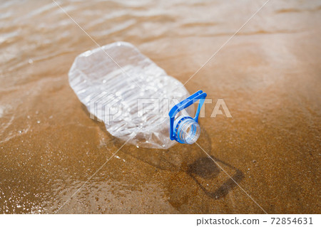 wasted plastic bottle on beach 72854631