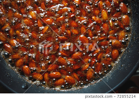 roasted almonds with cinnamon sugar cooking process, top view close-up roasted almonds with cinnamon sugar cooking process, top view close-up 72855214