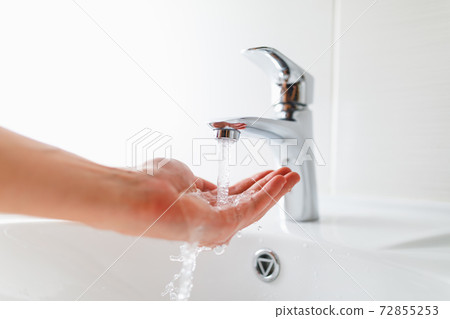 hand under faucet with water stream hand under faucet with water stream 72855253