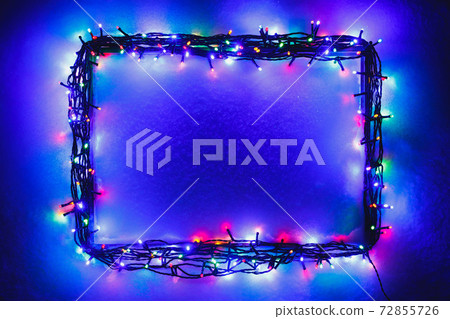 Christmas lights frame on snow background, blue and purple color Christmas lights frame on snow background, blue and purple color 72855726