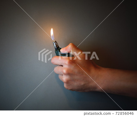 cigarette lighter igniting by a hand cigarette lighter igniting by a hand 72856046