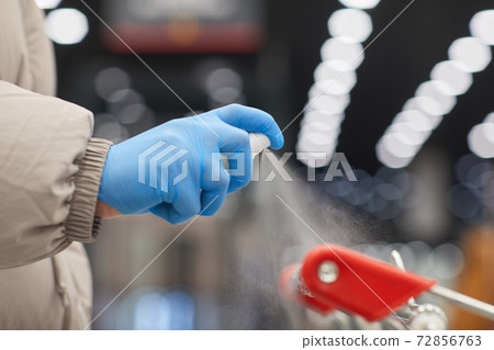 Woman with antiseptic in the shop 72856763