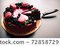 Delicious cake with fresh strawberries, raspberries, blueberry, currants. cut piece of cake and blade on wooden background. 72858729