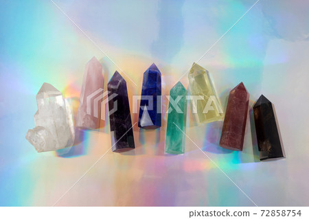 Healing Chakra crystals on halographic background. Meditation, Reiki or spiritual healing background. Healing Chakra crystals on halographic background. Meditation, Reiki or spiritual healing background. 72858754