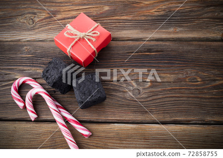 Christmas coal for bad kids and candys or gifts for good children. Christmas tradition in many countries. Christmas coal for bad kids and candys or gifts for good children. Christmas tradition in many countries. 72858755