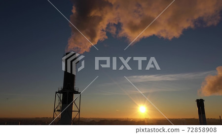 Industrial smoke stacks on sunset background, aerial shot Industrial smoke stacks on sunset background, aerial shot 72858908