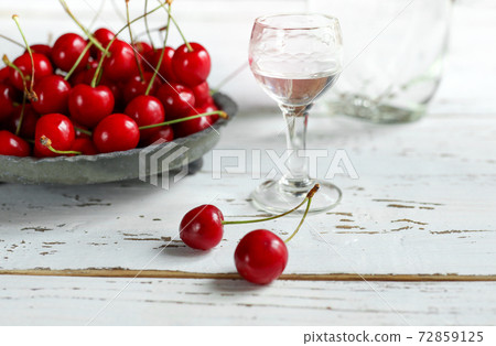 A shot with Kirsch or Kirschwasser and fresh cherry 72859125