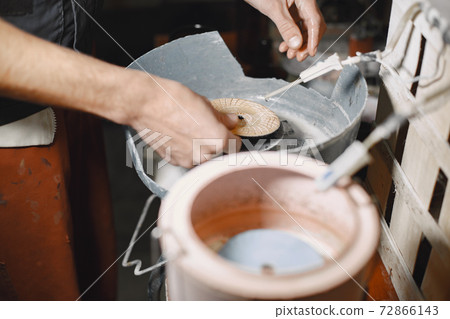 A man processes a bottle into a glass 72866143