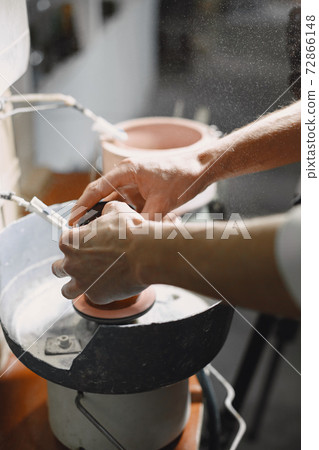 A man processes a bottle into a glass 72866148