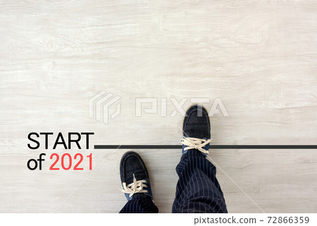 Men and feet standing on the starting line for 2021 Men and feet standing on the starting line for 2021 72866359