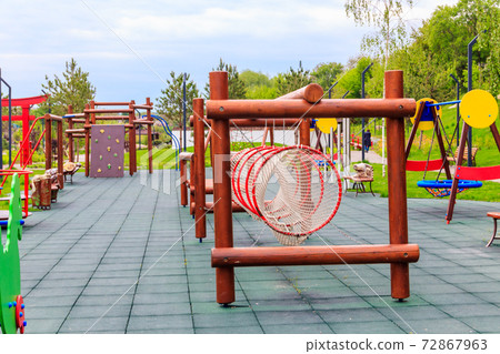 Empty colorful children's playground in a city park Empty colorful children's playground in a city park 72867963
