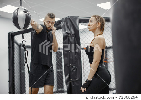 Portrait of a confident young woman in boxing gloves 72868264
