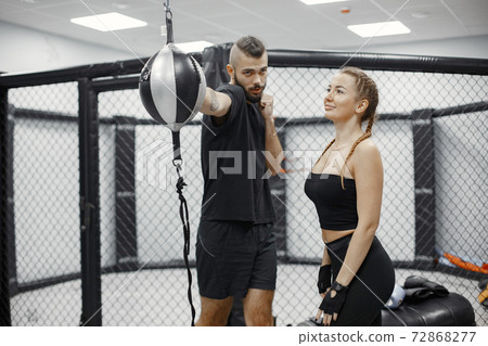 Portrait of a confident young woman in boxing gloves 72868277